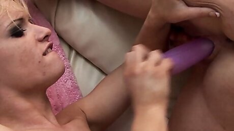 Massaging her soaking wet pussy after the lesbians take their fuck to the sofa