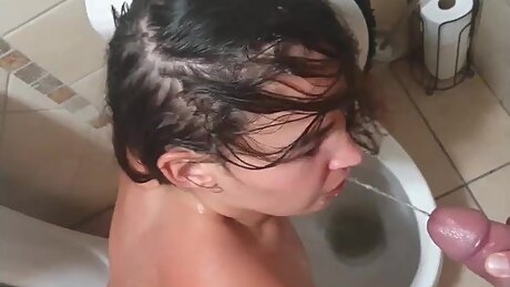 Teen slut dragged to the toilet to get pissed on, slapped and spat on. Cock sucking