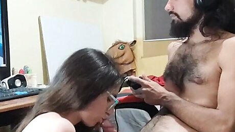 Stepsister gives her gamer stepbrother a blowjob while playing a videogame