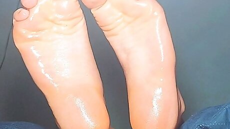 Girl show their soles with oil