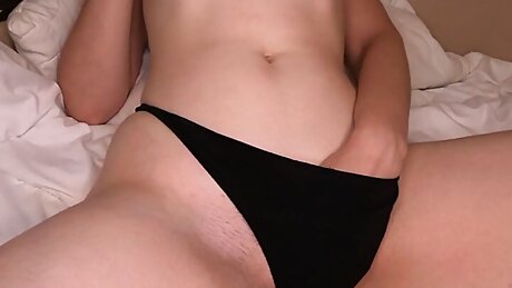 the girl masturbates through her panties and gently groans ending