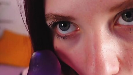 Girl sucking two dildos and sensually waving her big ass