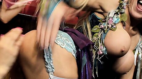 Lusty blondes fuck with a dildo while busty brunette is watching