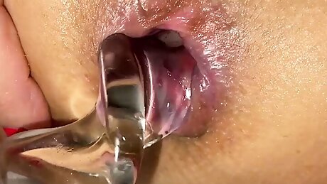 Blonde Lily is playing with a big exotic glass toy. Stretches her ass and cums.