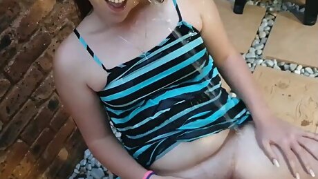 Brunette In Dress Gets Pissed On While Sitting On A Chair Outside After She Pissed On The Floor, Undressing