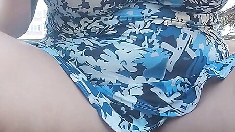 Pissing secret on a bench in a garden